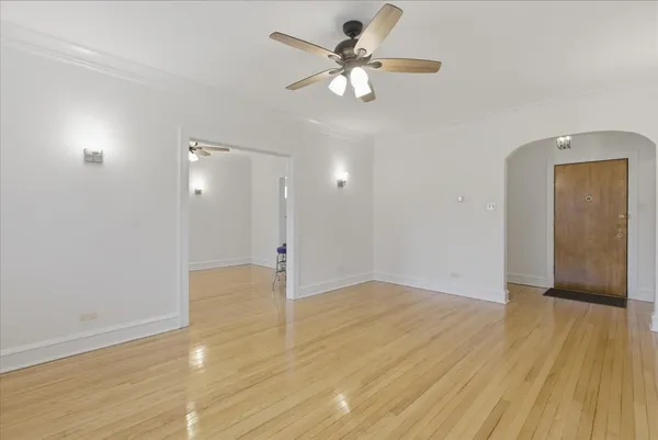 a view of an empty room and wooden floor