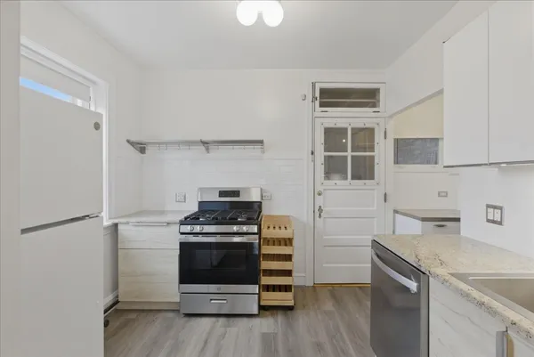 a kitchen with a stove and a refrigerator