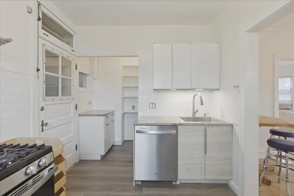 a kitchen with cabinets appliances and a window
