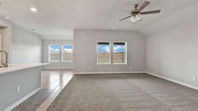 a large kitchen with stainless steel appliances kitchen island granite countertop a stove and a sink