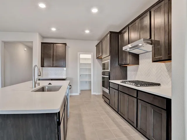 a view of a kitchen with a sink and microwave