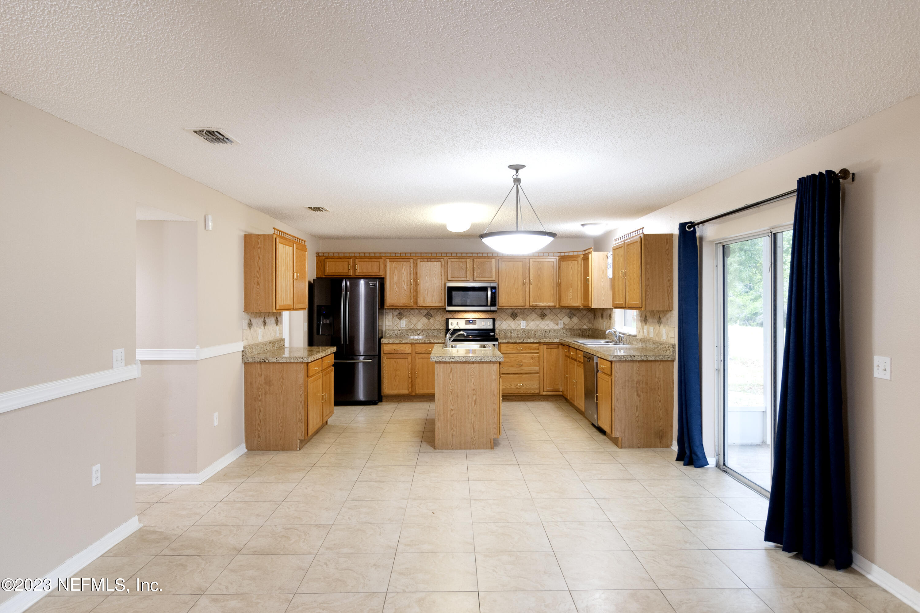 1490 Seawolf Trail Jacksonville, FL 32221 - Photo 11 of 36 a kitchen with a refrigerator and a sink