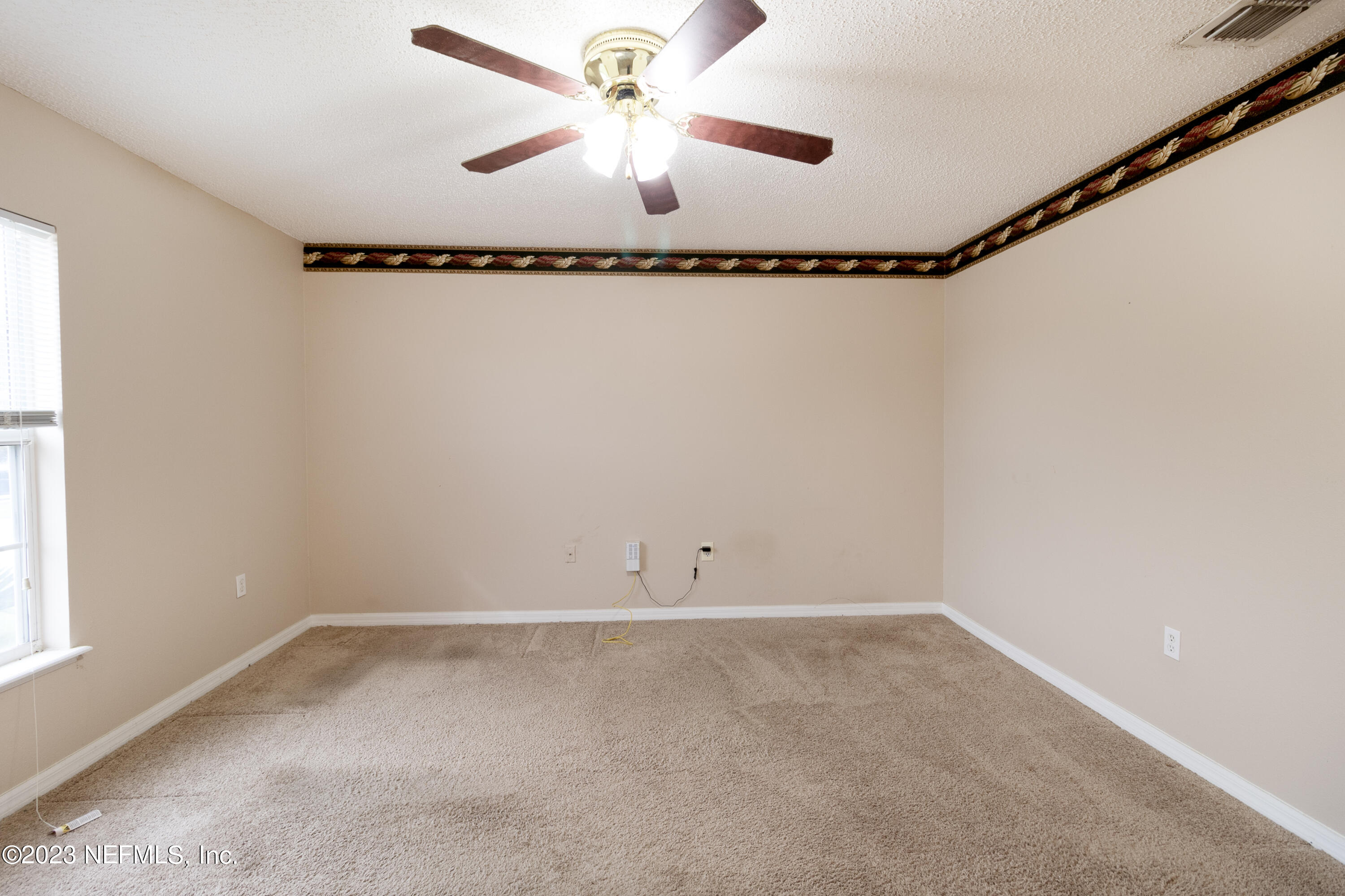 1490 Seawolf Trail Jacksonville, FL 32221 - Photo 18 of 36 an empty room with a window and a ceiling fan