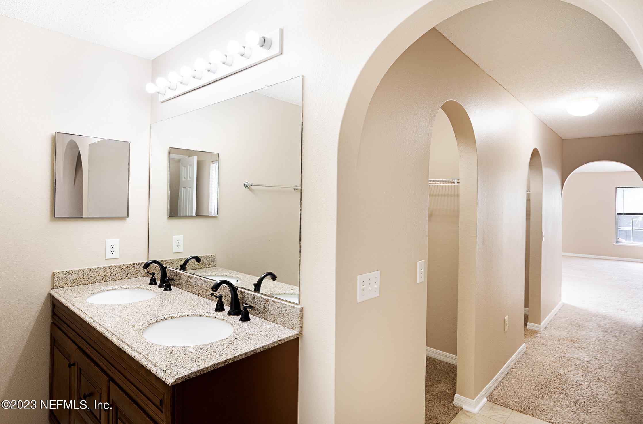 1490 Seawolf Trail Jacksonville, FL 32221 - Photo 26 of 36 a bathroom with a granite countertop sink and a mirror