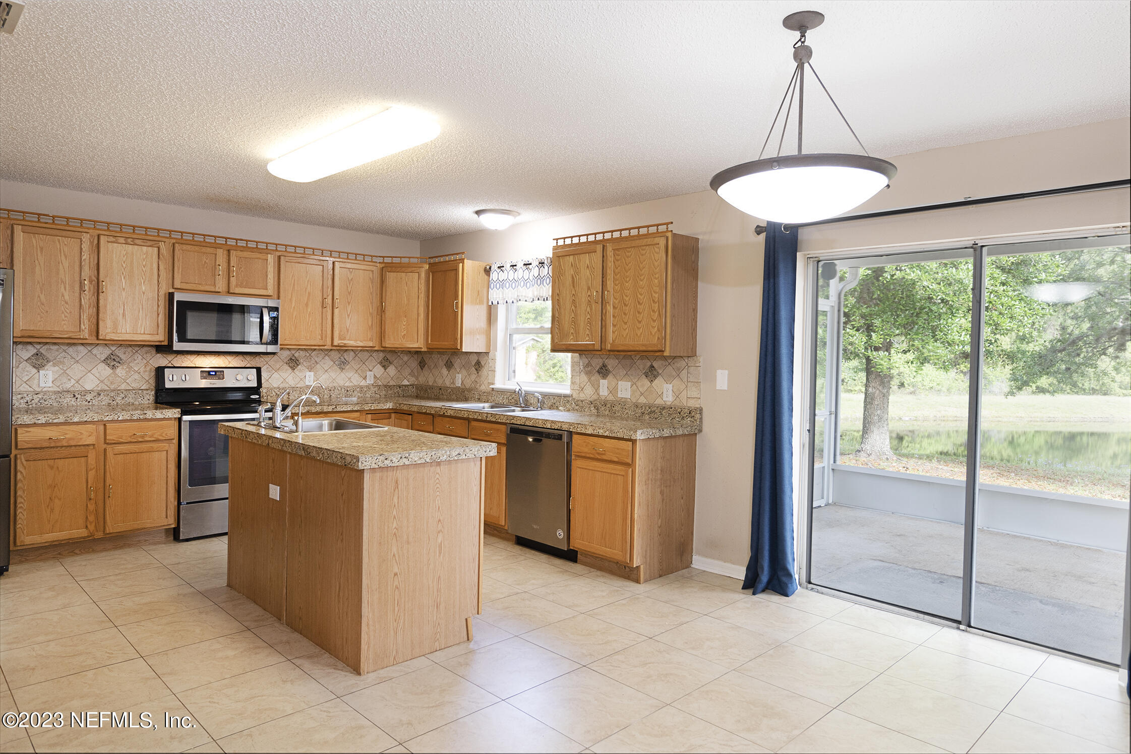 1490 Seawolf Trail Jacksonville, FL 32221 - Photo 7 of 36 a kitchen with a refrigerator a stove top oven and a sink