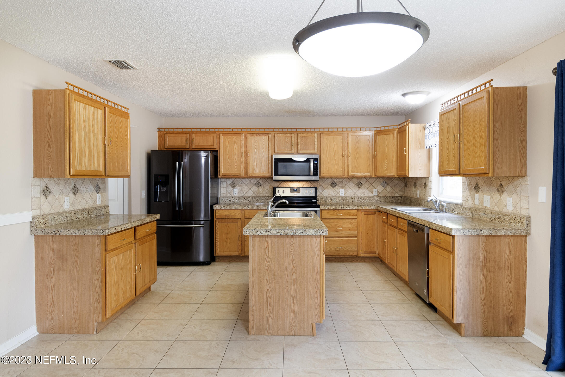1490 Seawolf Trail Jacksonville, FL 32221 - Photo 8 of 36 a kitchen with stainless steel appliances granite countertop a stove refrigerator sink and dishwasher