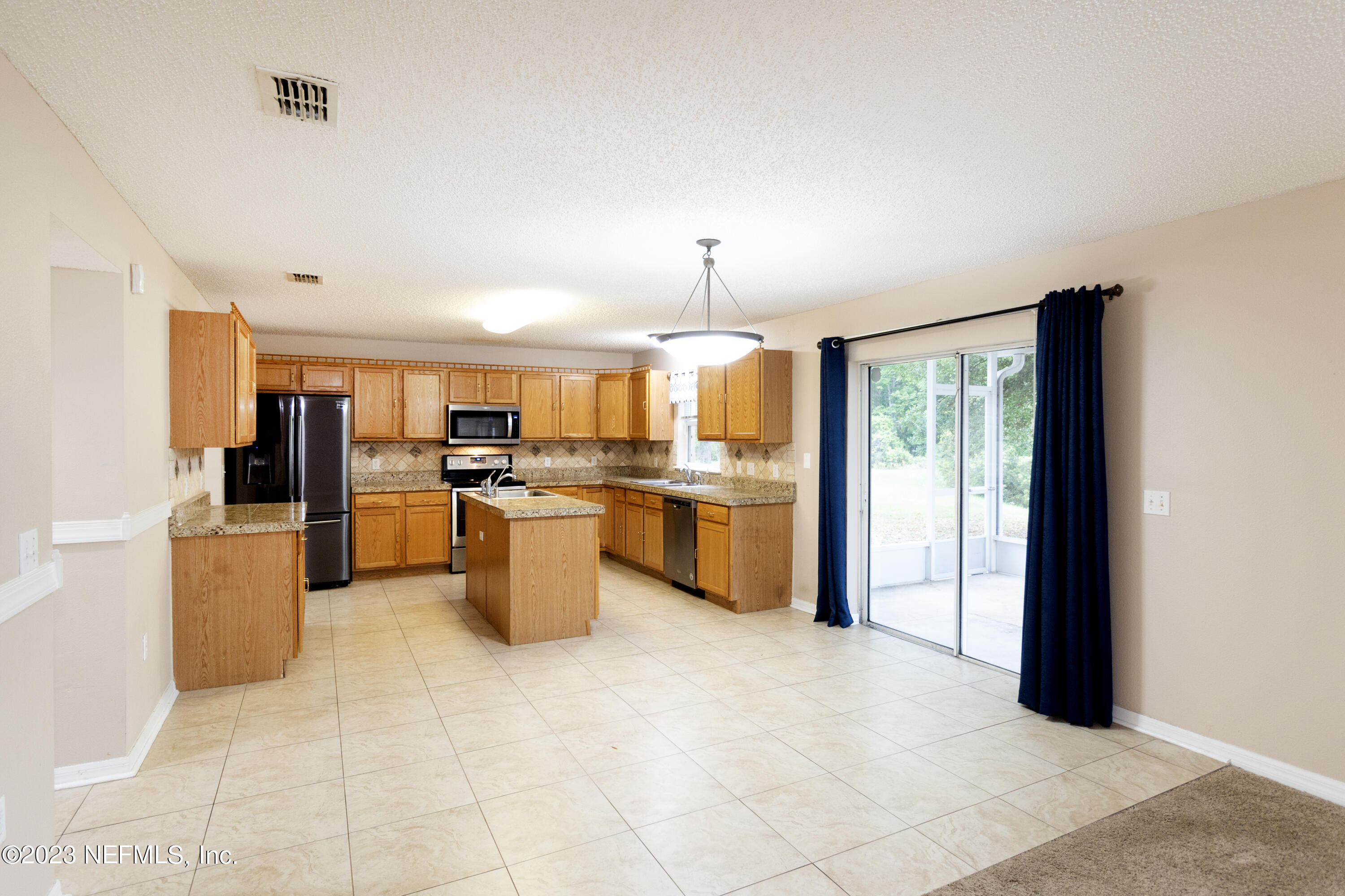 1490 Seawolf Trail Jacksonville, FL 32221 - Photo 9 of 36 a kitchen with stainless steel appliances a stove top oven a sink a counter top space and cabinets