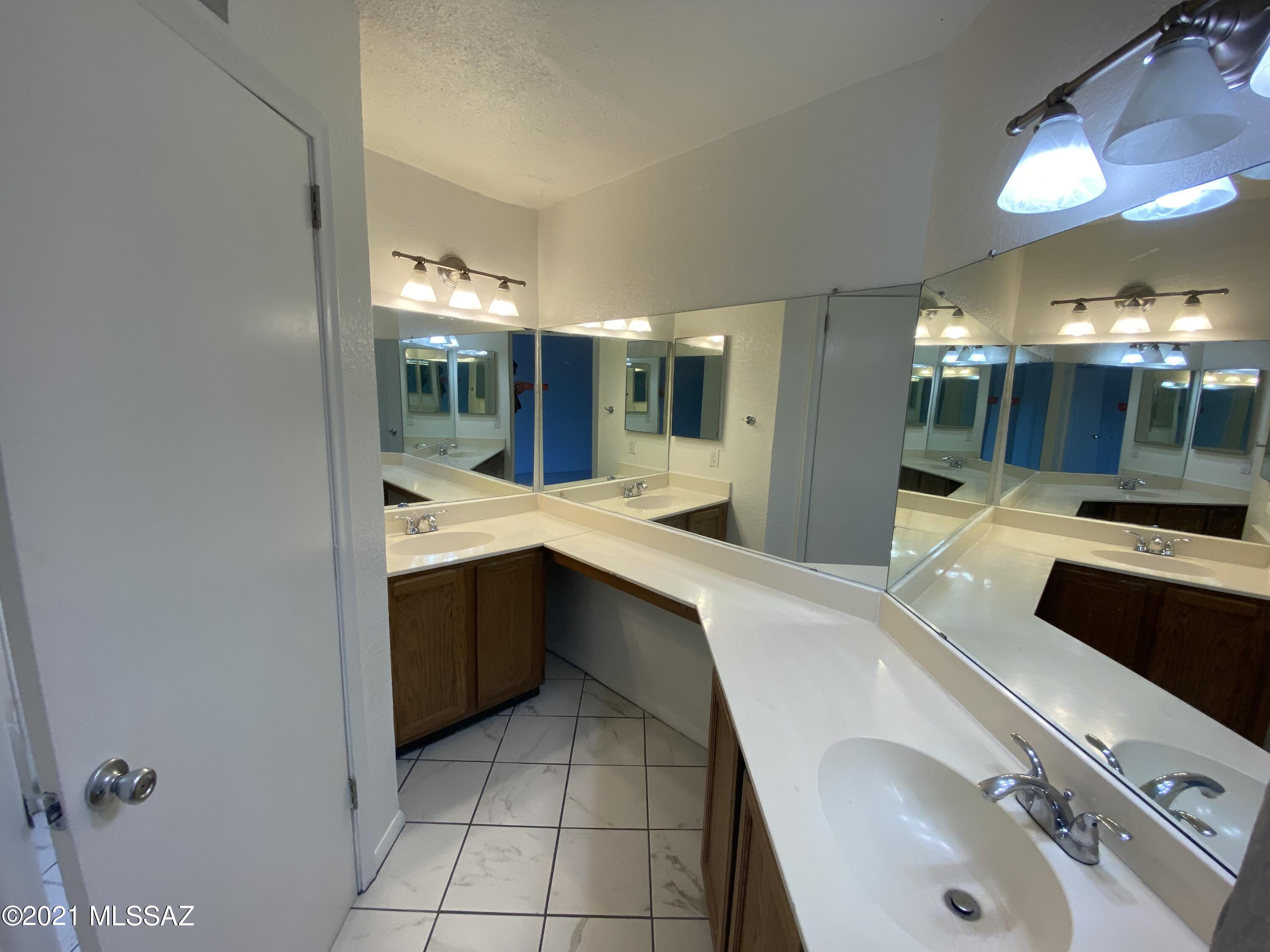 210 East Pastime Road Tucson, AZ 85705 - Photo 21 of 29 a bathroom with a sink and mirror