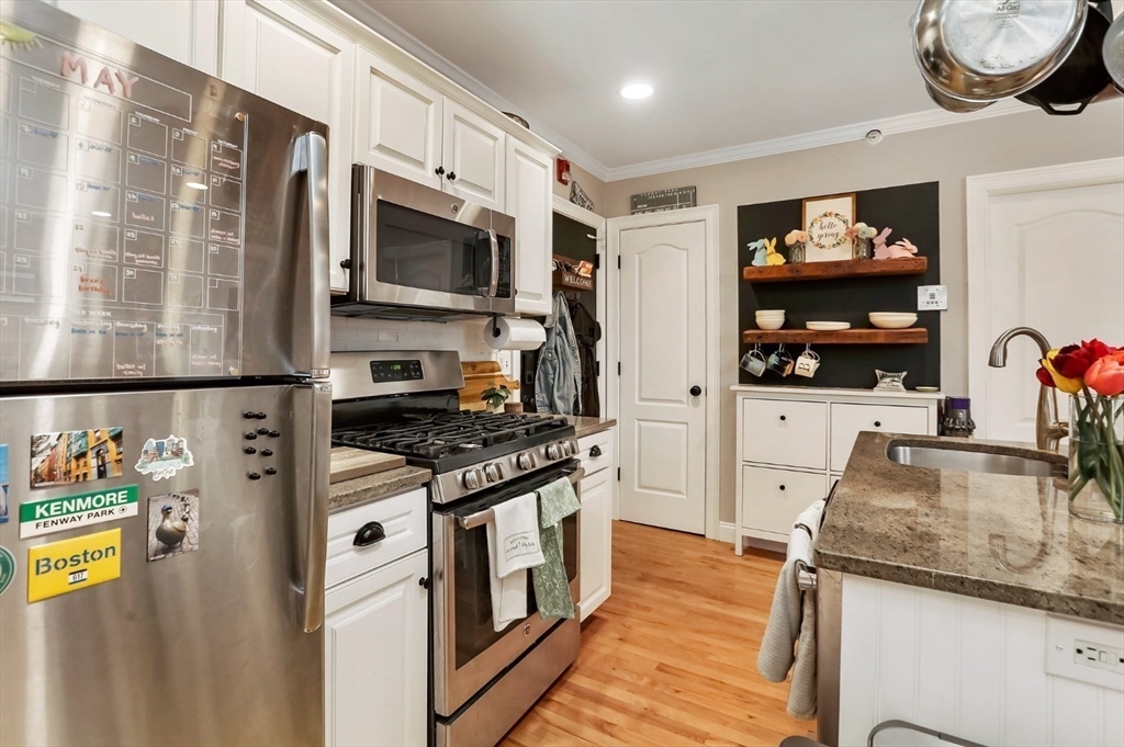 454 Hanover Street, Unit 4 Boston, MA 02113 - Photo 8 of 23 a kitchen with stainless steel appliances granite countertop a stove and a microwave