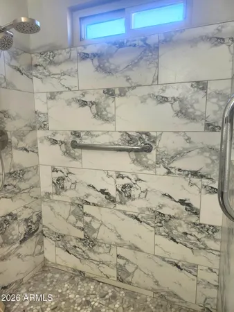 a bathroom with a granite countertop toilet sink and mirror