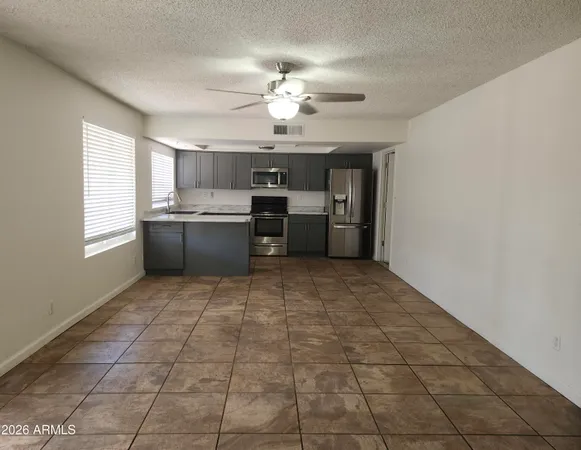 a kitchen with stainless steel appliances a chandelier and a view of kitchen