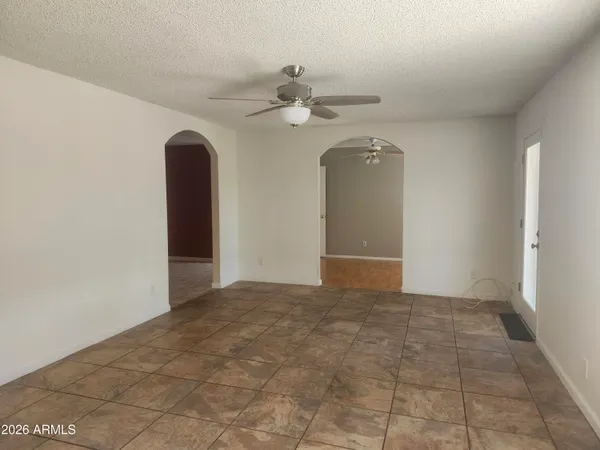 a view of an empty room with a ceiling fan