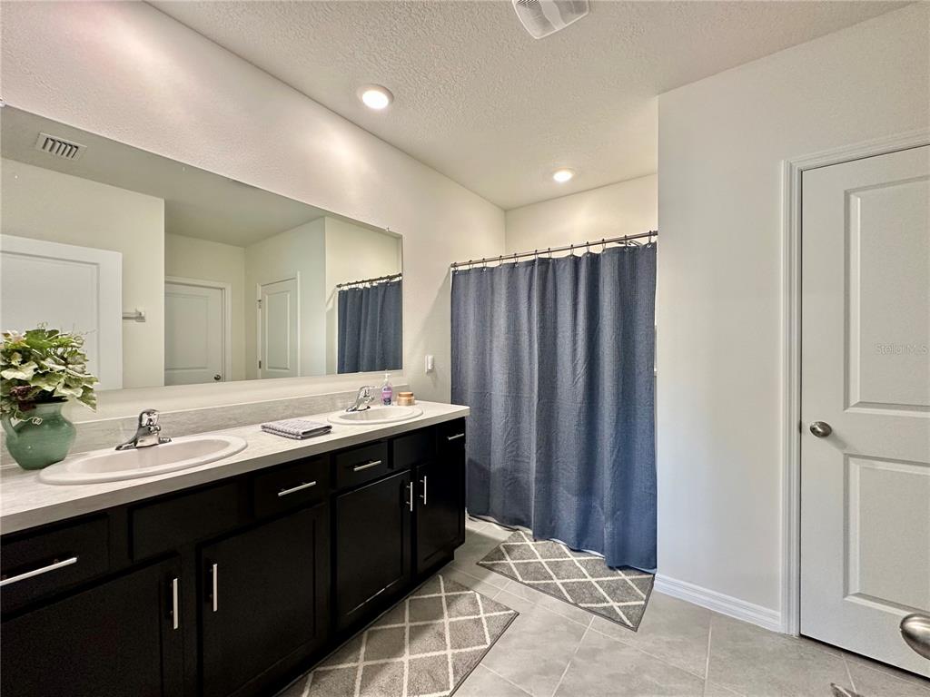 19 Hickory Course Radiel Ocala, FL 34472 - Photo 11 of 22 a bathroom with a double vanity sink and a mirror