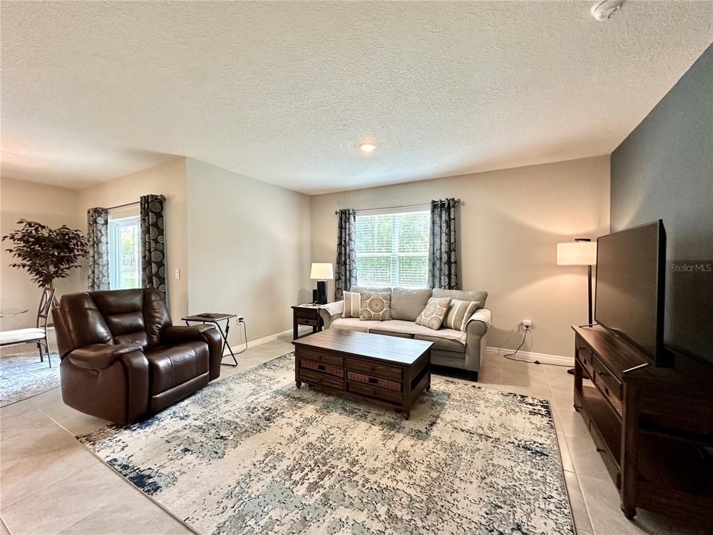 19 Hickory Course Radiel Ocala, FL 34472 - Photo 3 of 22 a living room with furniture flat screen tv and a large window