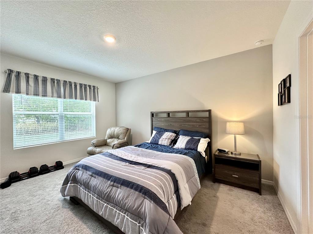 19 Hickory Course Radiel Ocala, FL 34472 - Photo 9 of 22 a bedroom with a bed a window and a night stand