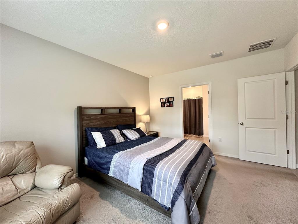 19 Hickory Course Radiel Ocala, FL 34472 - Photo 10 of 22 a bedroom with a bed and couch