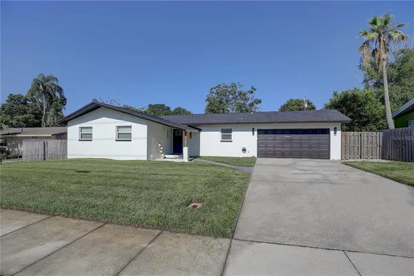a view of a house with a yard and a garage