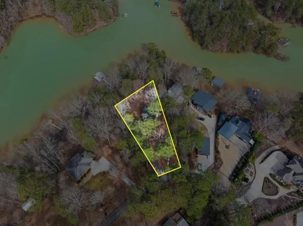 an aerial view of a house with outdoor space and lake view