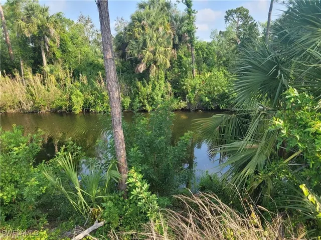 a view of a lake with a house in the background