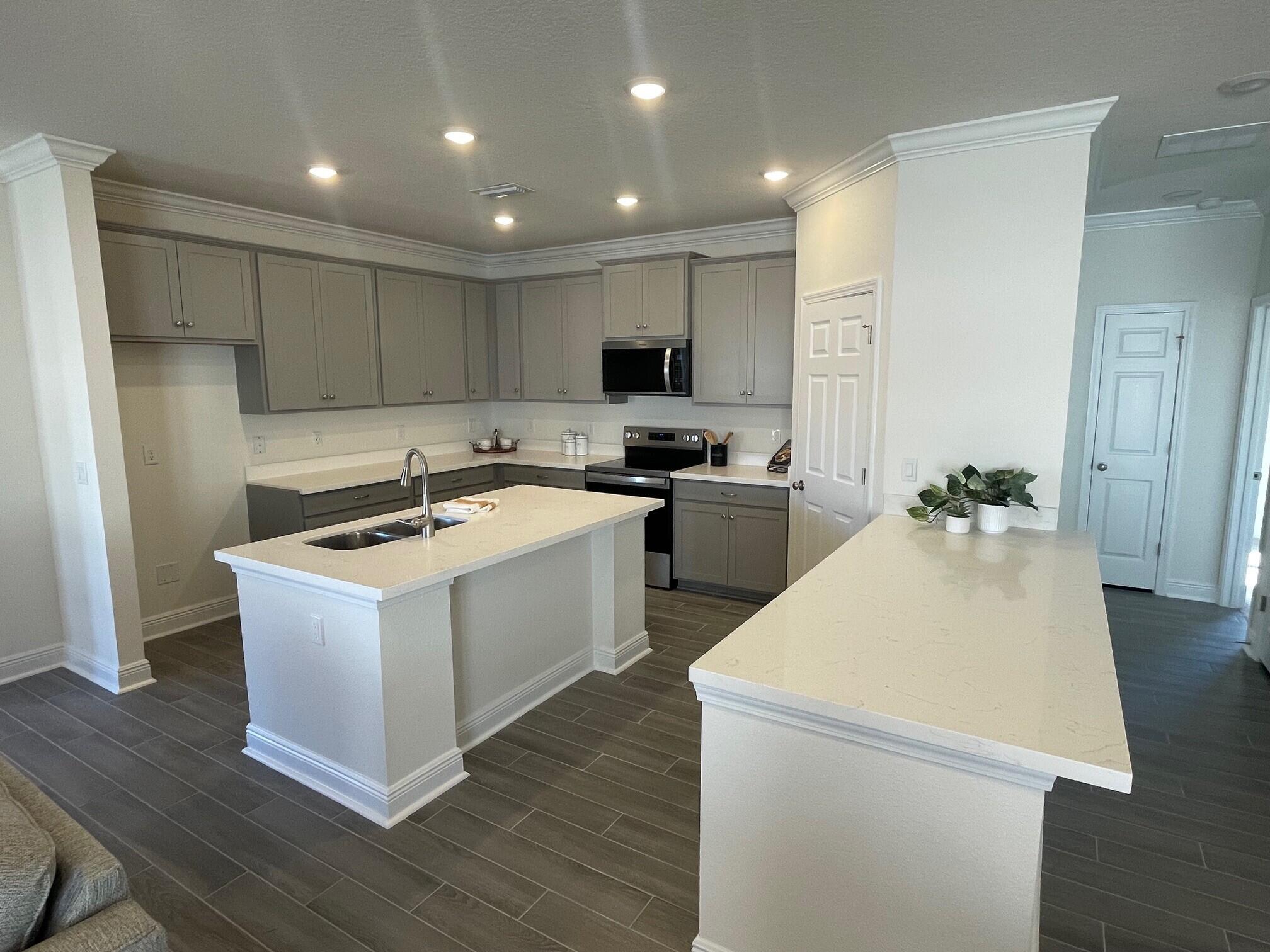 55 Splendor Run Ponce de Leon, FL 32455 - Photo 2 of 4 a kitchen with a sink a stove and refrigerator