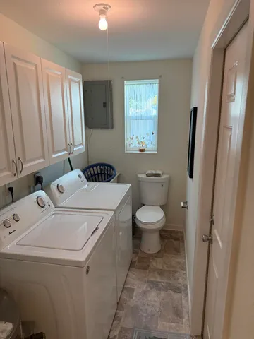 a bathroom with a toilet sink and window