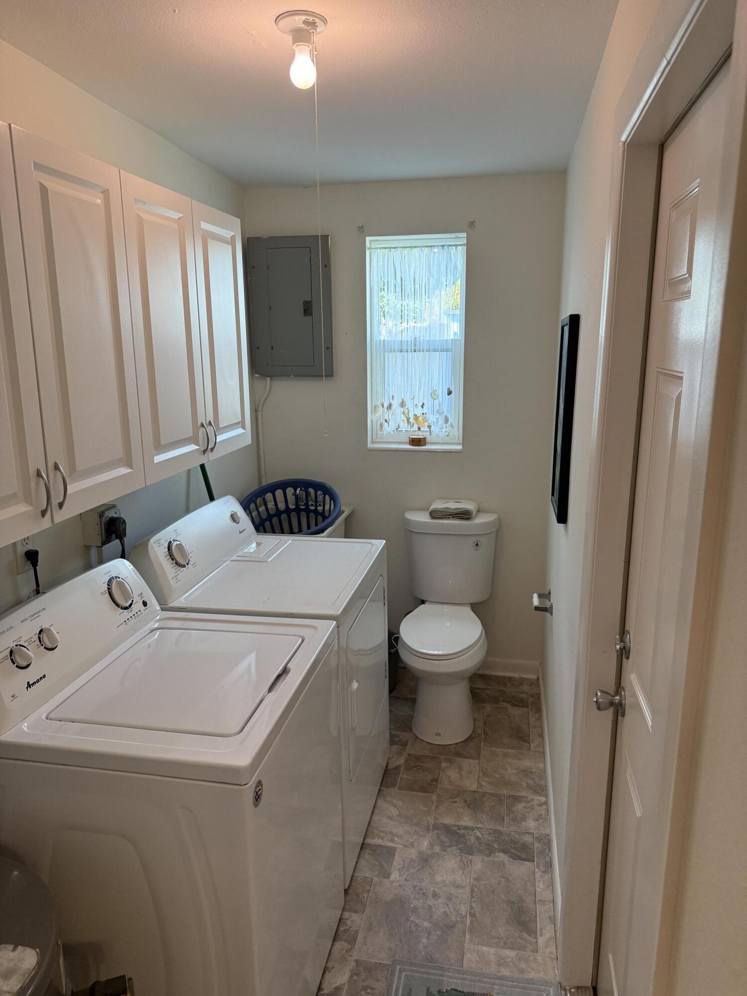 440 Southeast Fini Drive Stuart, FL 34996 - Photo 14 of 17 a bathroom with a toilet sink and window
