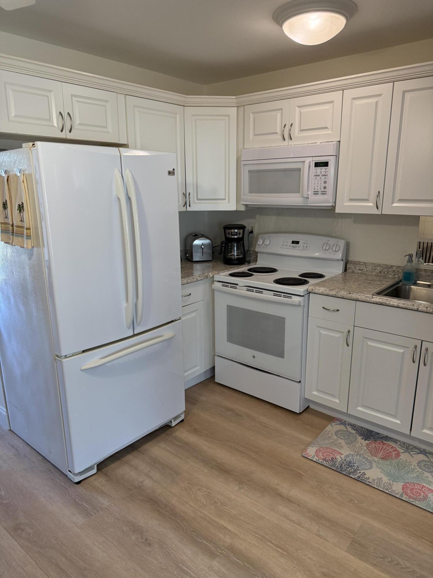 440 Southeast Fini Drive Stuart, FL 34996 - Photo 6 of 17 a white refrigerator freezer sitting in a kitchen