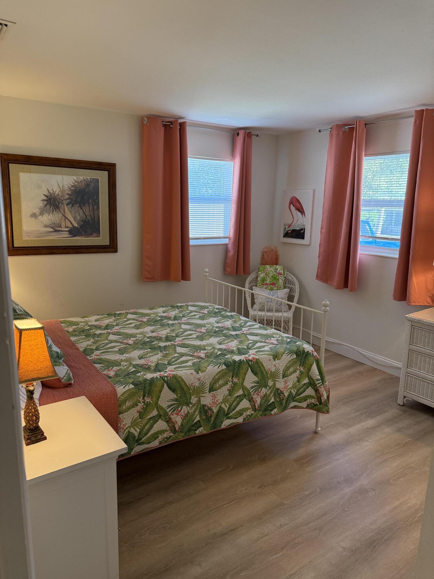 440 Southeast Fini Drive Stuart, FL 34996 - Photo 10 of 17 a bedroom with a bed and dresser with wooden floor