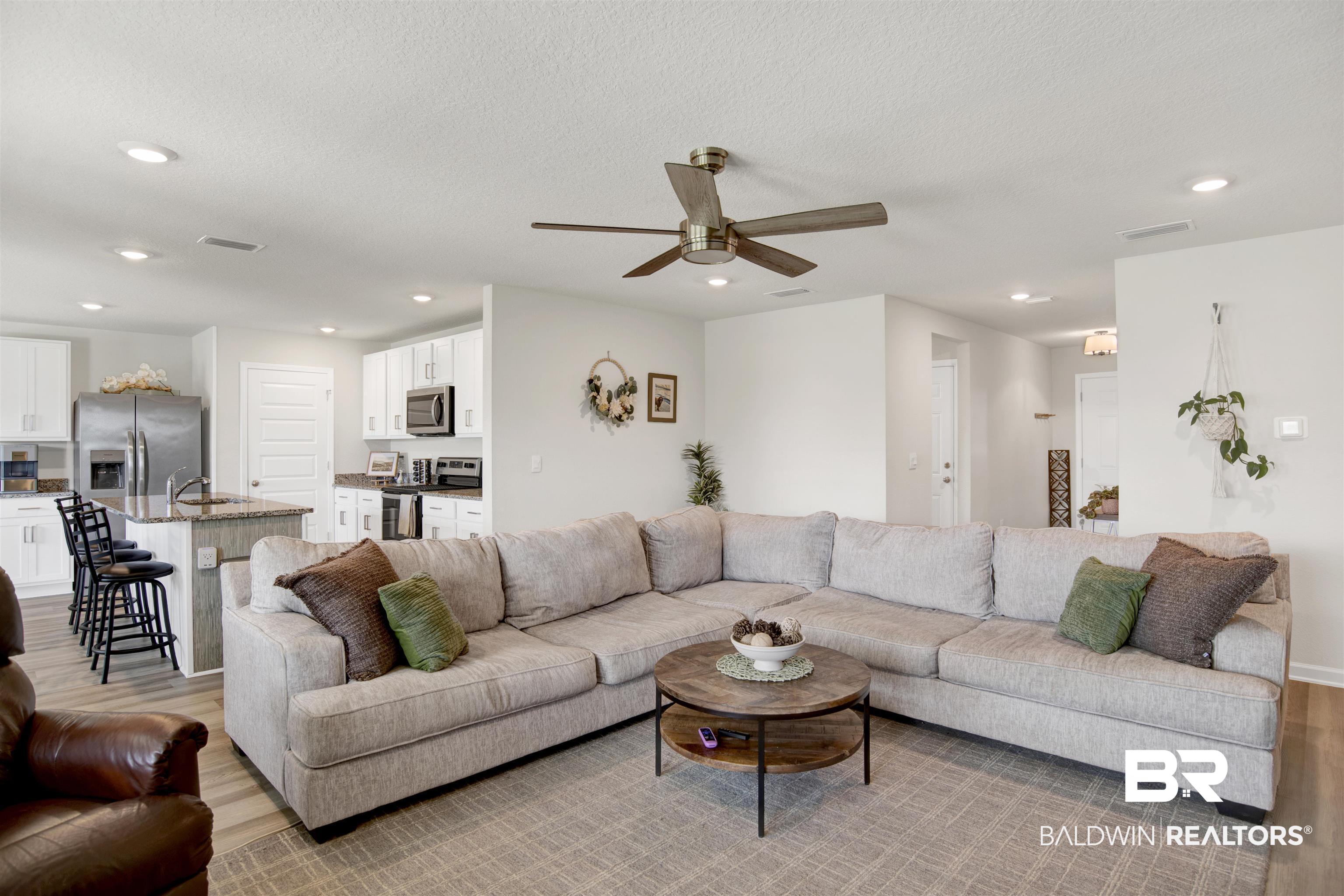 22301 Early Dawn Circle Foley, AL 36535 - Photo 20 of 45 Open-concept living space featuring recessed lighting, a ceiling fan, and wood-finish flooring