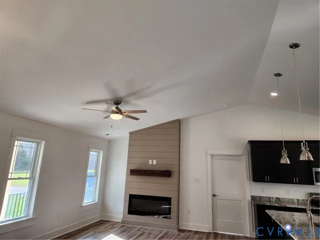 a view of an empty room with exposed radiator and fireplace