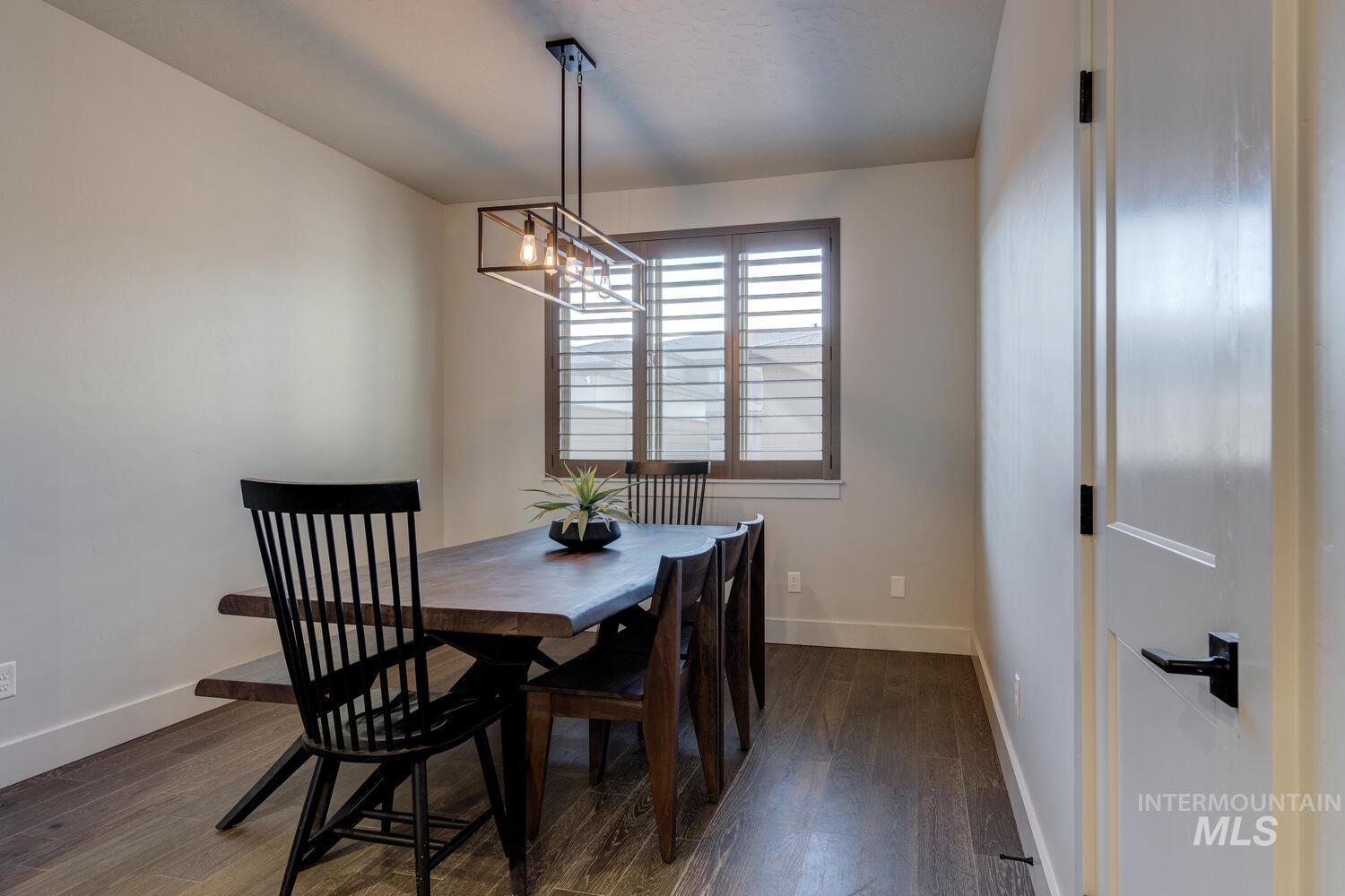 3255 South Millbrook Way Boise, ID 83716 - Photo 15 of 37 Dining area with dark wood-style flooring and a chandelier