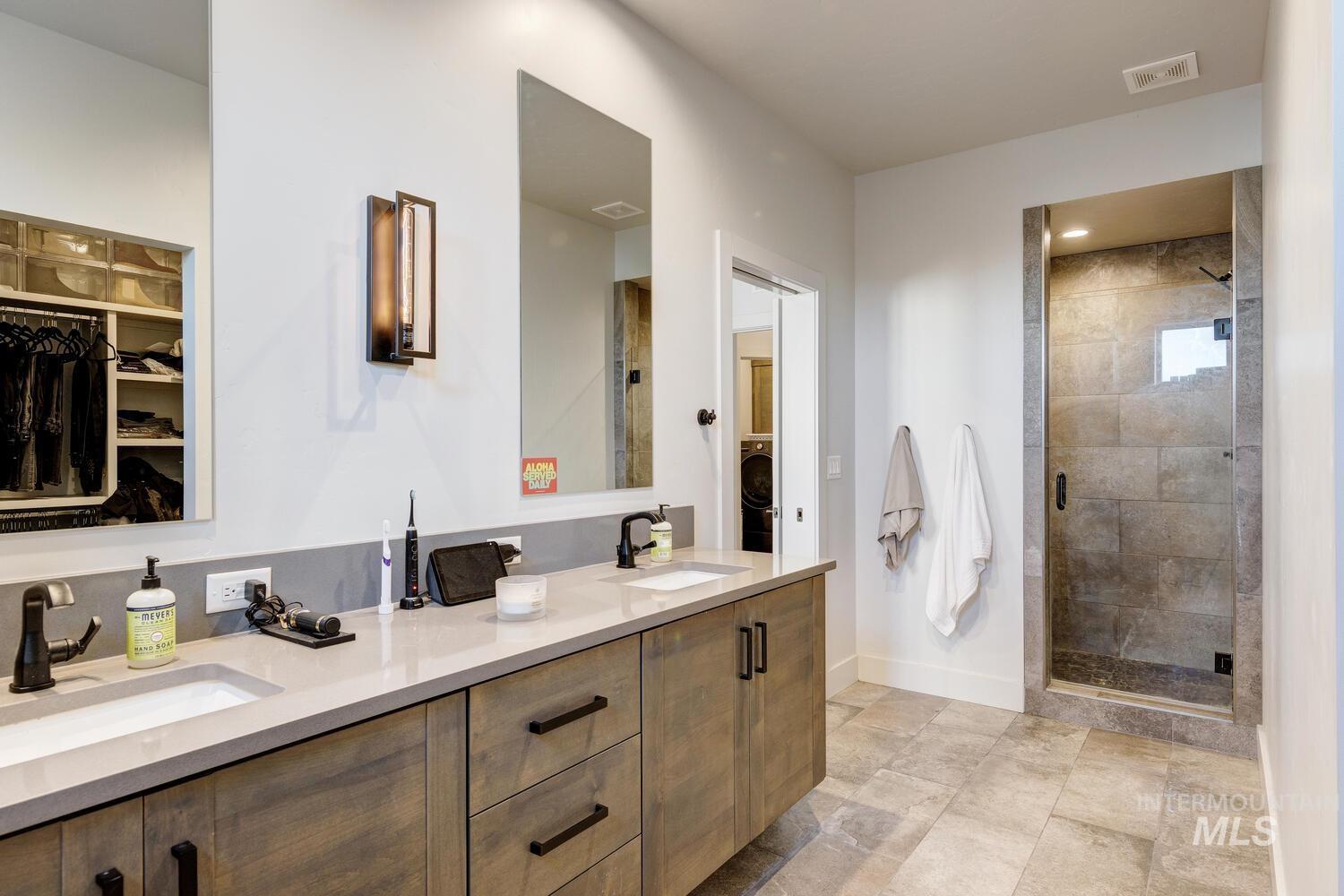 3255 South Millbrook Way Boise, ID 83716 - Photo 26 of 37 Bathroom with a spacious closet, double vanity, and a stall shower