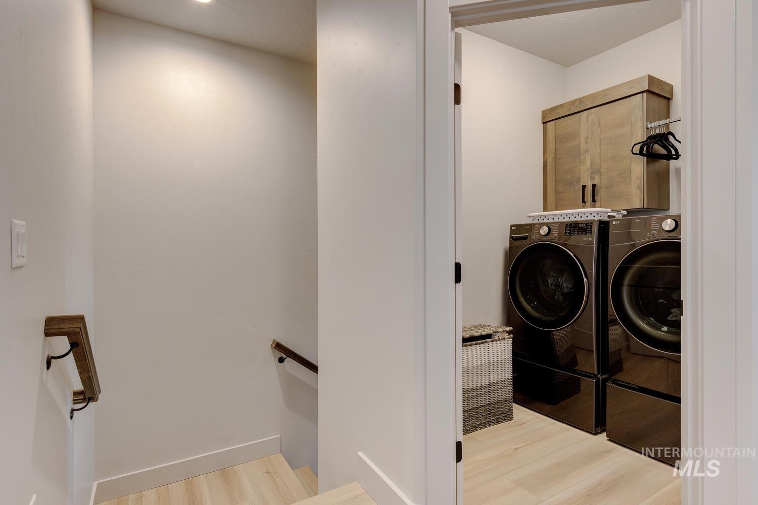 3255 South Millbrook Way Boise, ID 83716 - Photo 28 of 37 Washroom with light wood-type flooring and washer and dryer