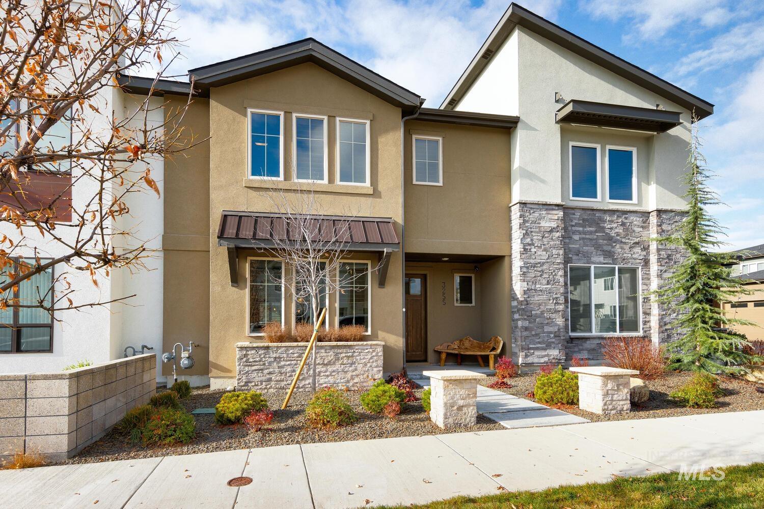 3255 South Millbrook Way Boise, ID 83716 - Photo 3 of 37 View of front of house featuring stucco siding, stone siding, and covered porch