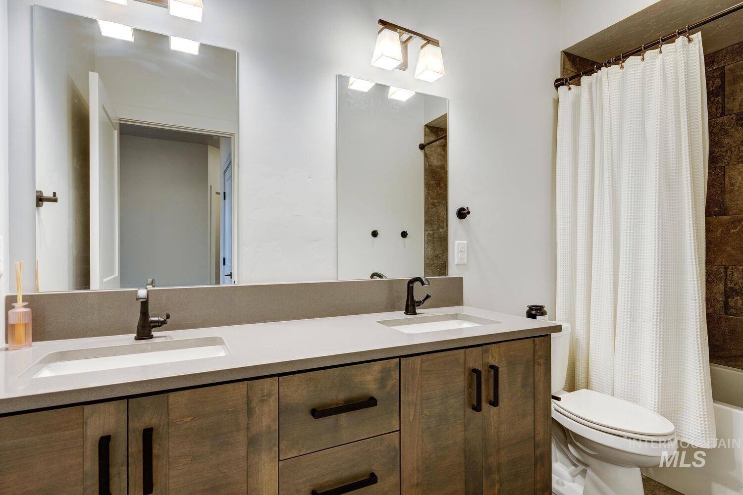 3255 South Millbrook Way Boise, ID 83716 - Photo 31 of 37 Bathroom featuring shower / tub combo with curtain and double vanity