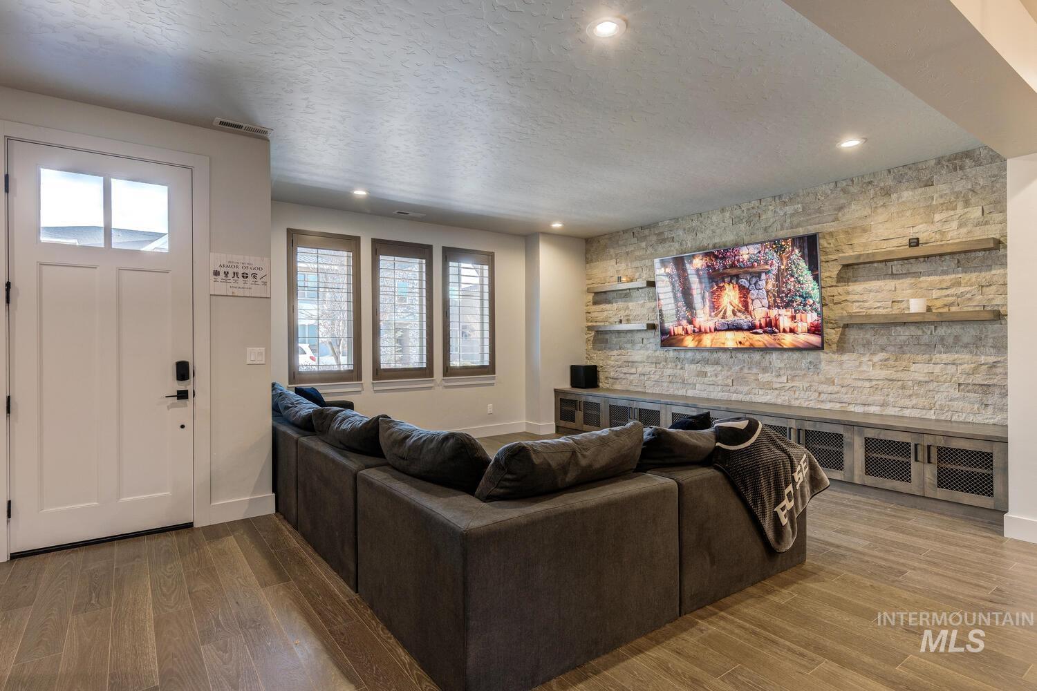 3255 South Millbrook Way Boise, ID 83716 - Photo 6 of 37 Living area featuring light wood finished floors, a textured ceiling, recessed lighting, and an accent wall