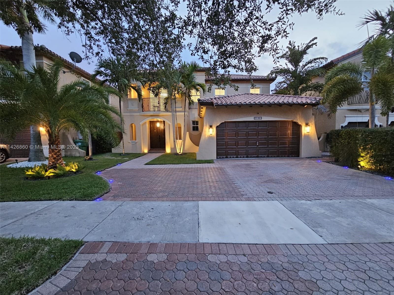 a front view of a house with a yard and a garage
