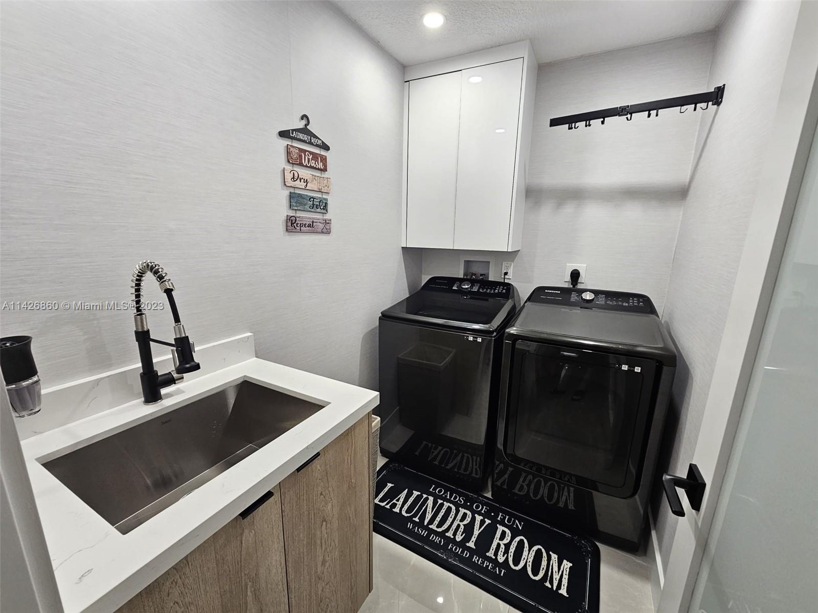 3166 Southwest 155th Avenue Miami, FL 33185 - Photo 11 of 27 a utility room with sink dryer and washer