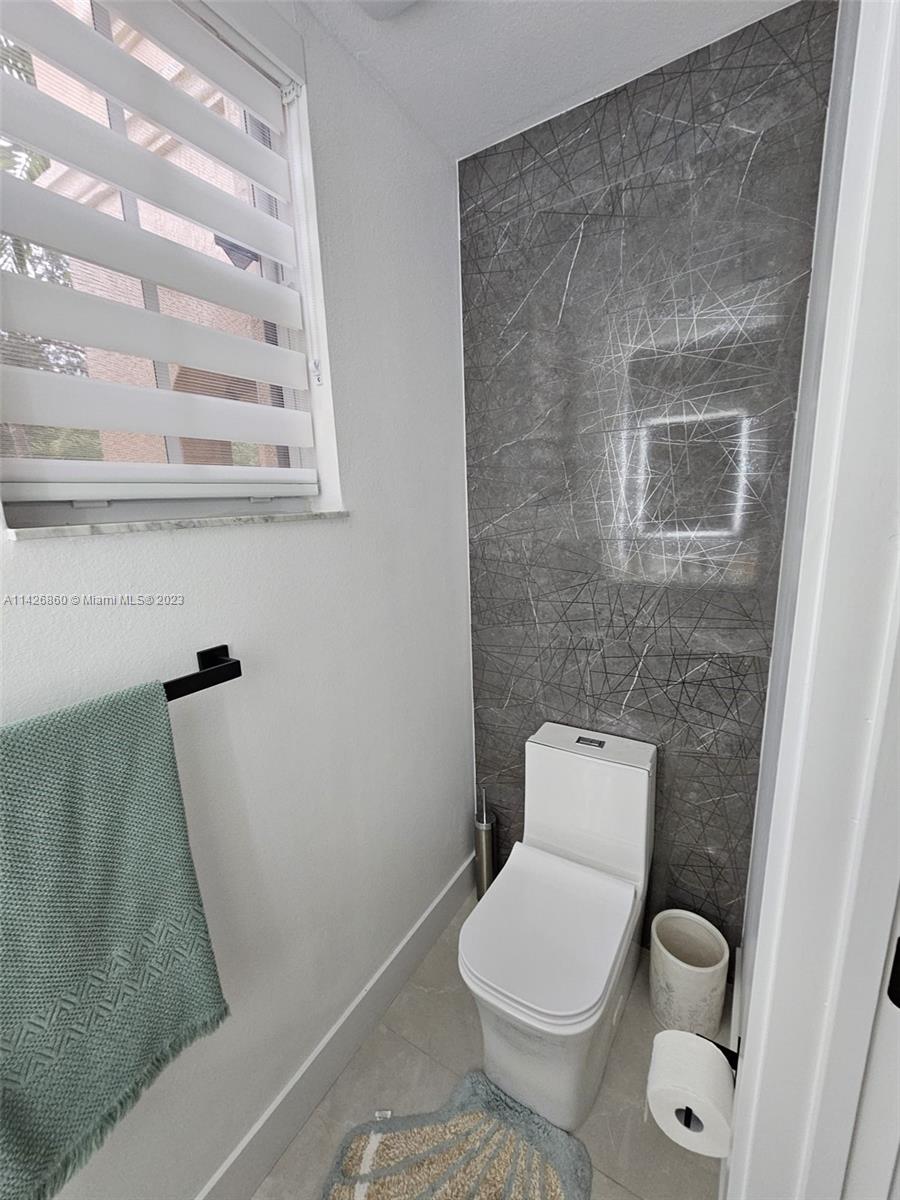 3166 Southwest 155th Avenue Miami, FL 33185 - Photo 13 of 27 a white toilet sitting next to a shower