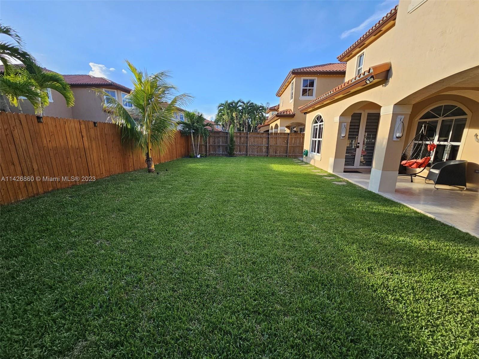 3166 Southwest 155th Avenue Miami, FL 33185 - Photo 15 of 27 a front view of house with yard and seating area