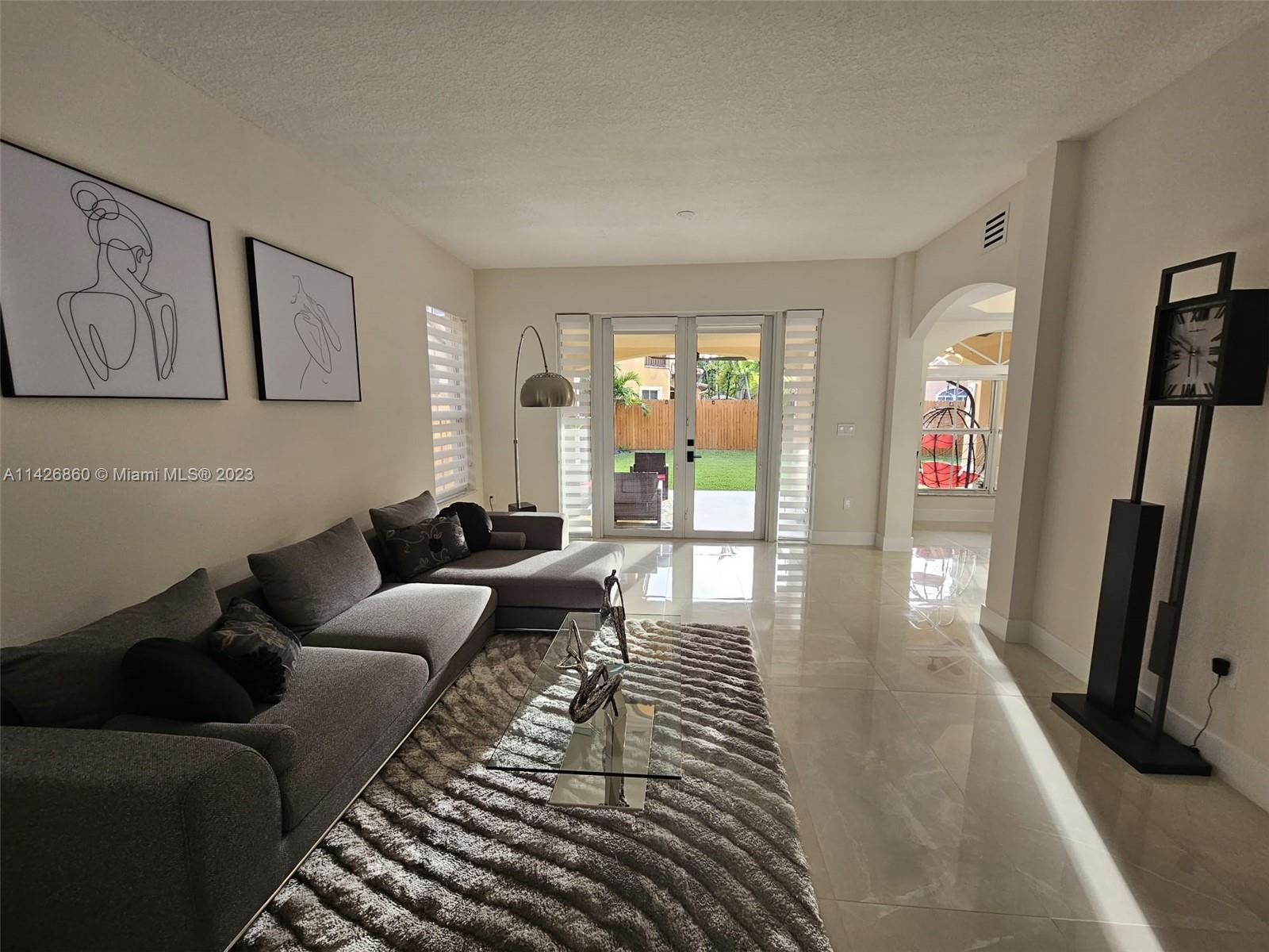 3166 Southwest 155th Avenue Miami, FL 33185 - Photo 2 of 27 a living room with furniture and a fireplace