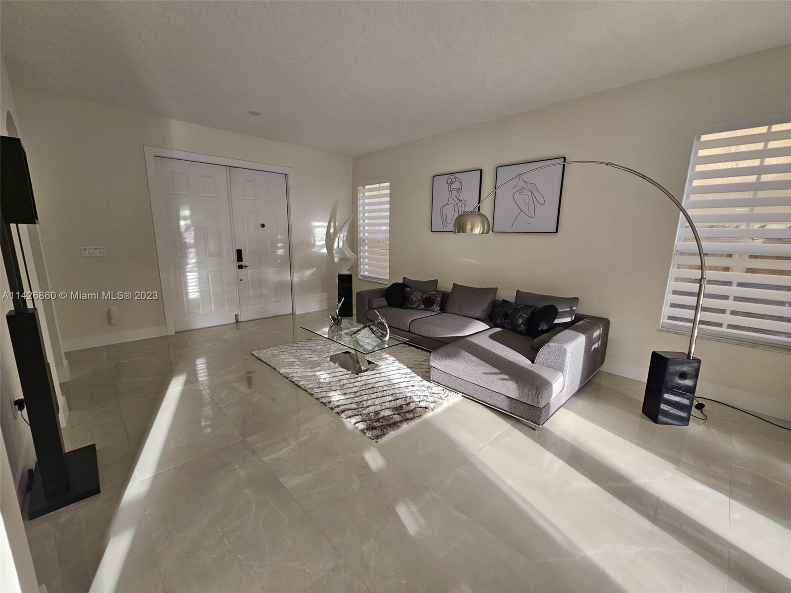 3166 Southwest 155th Avenue Miami, FL 33185 - Photo 3 of 27 a living room with furniture and a window