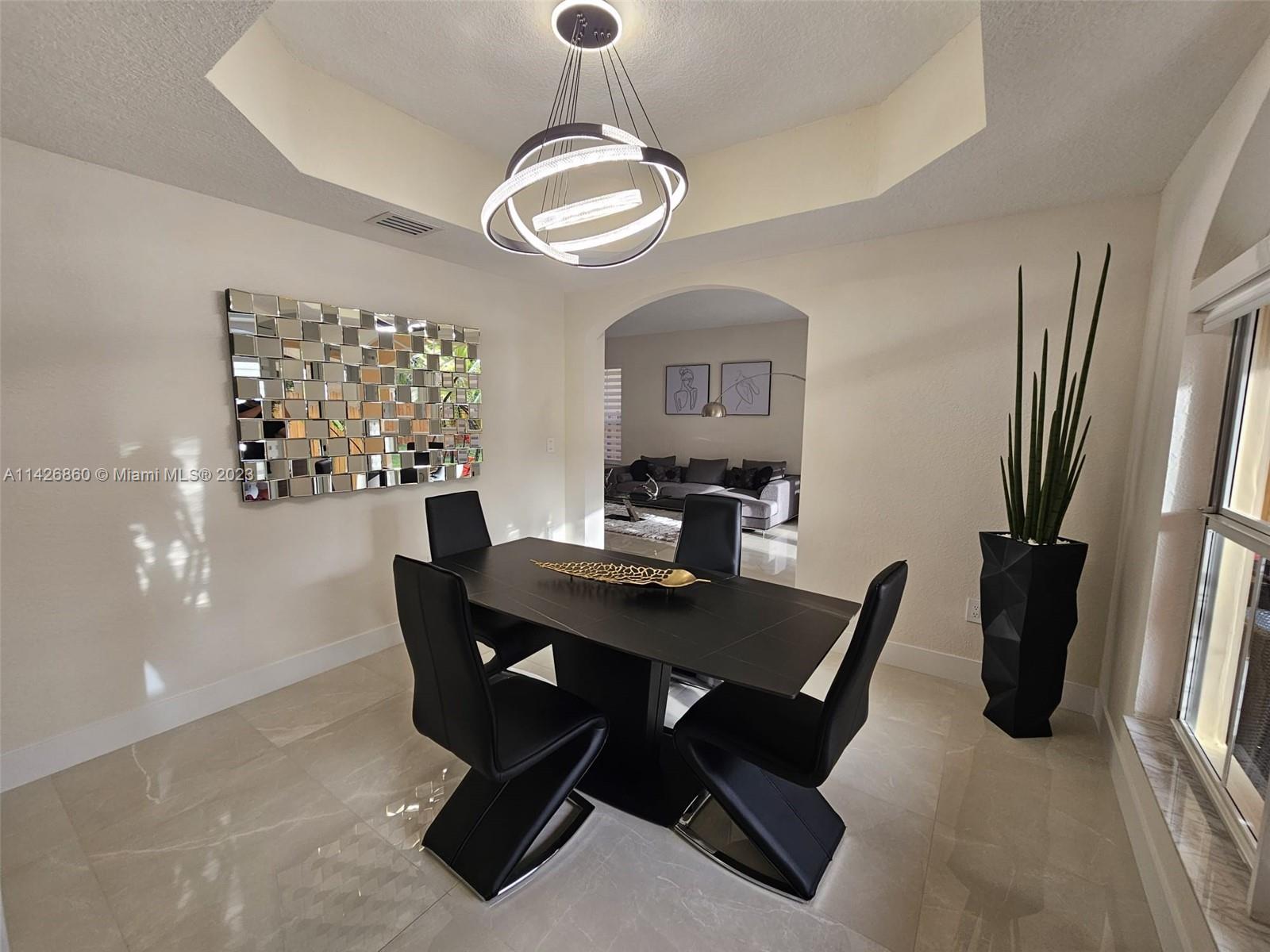 3166 Southwest 155th Avenue Miami, FL 33185 - Photo 4 of 27 a view of a dining room with furniture