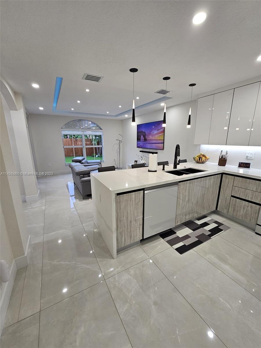 3166 Southwest 155th Avenue Miami, FL 33185 - Photo 6 of 27 a kitchen with stainless steel appliances a sink a counter top space cabinets and a window