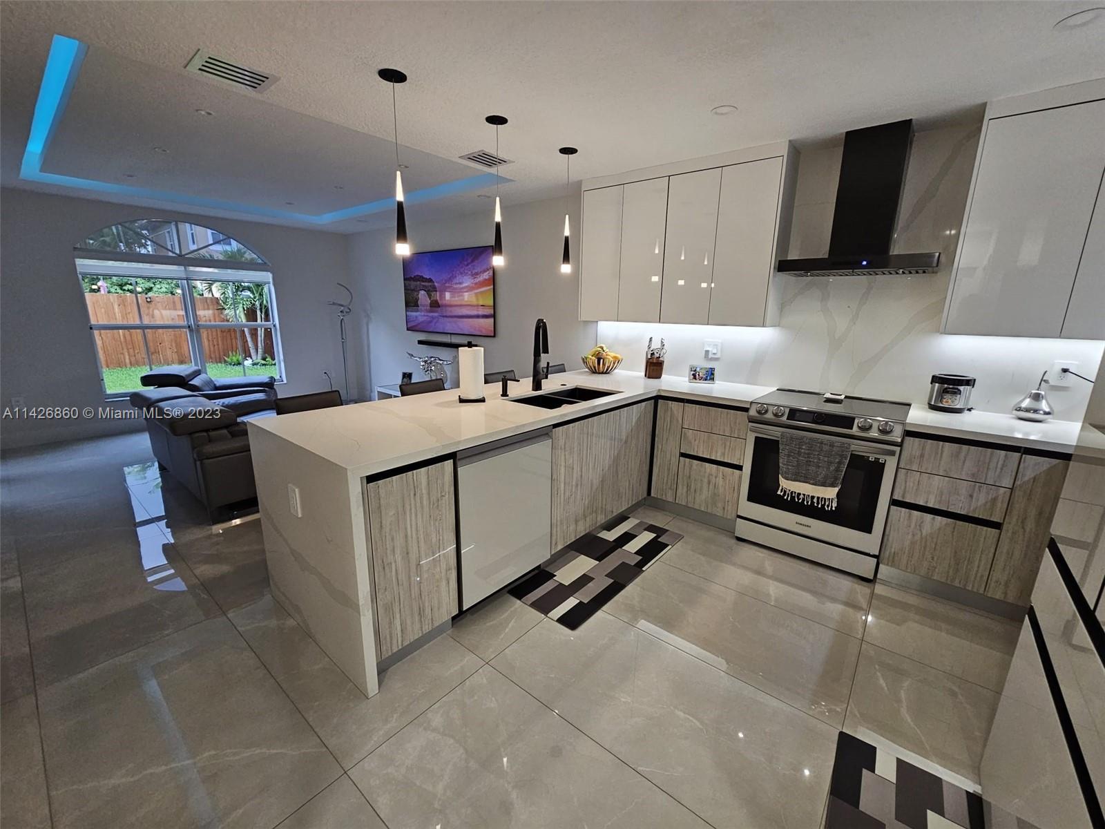 3166 Southwest 155th Avenue Miami, FL 33185 - Photo 8 of 27 a kitchen with a sink appliances and cabinets