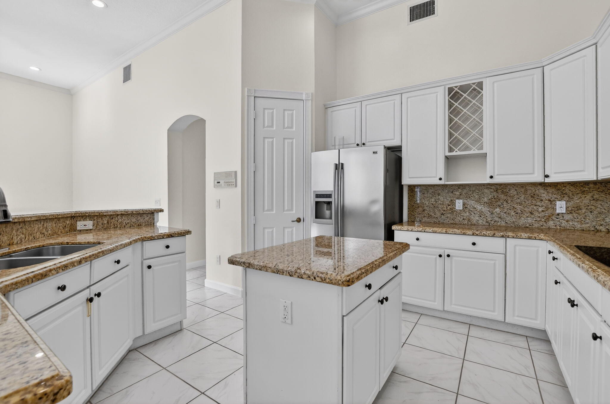 21719 Marigot Drive Boca Raton, FL 33428 - Photo 10 of 53 a kitchen with white cabinets and refrigerator