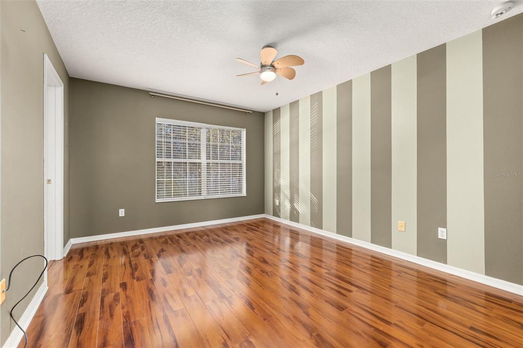 11781 Fitzgerald Butler Road Orlando, FL 32836 - Photo 21 of 37 a view of an empty room with wooden floor and a window