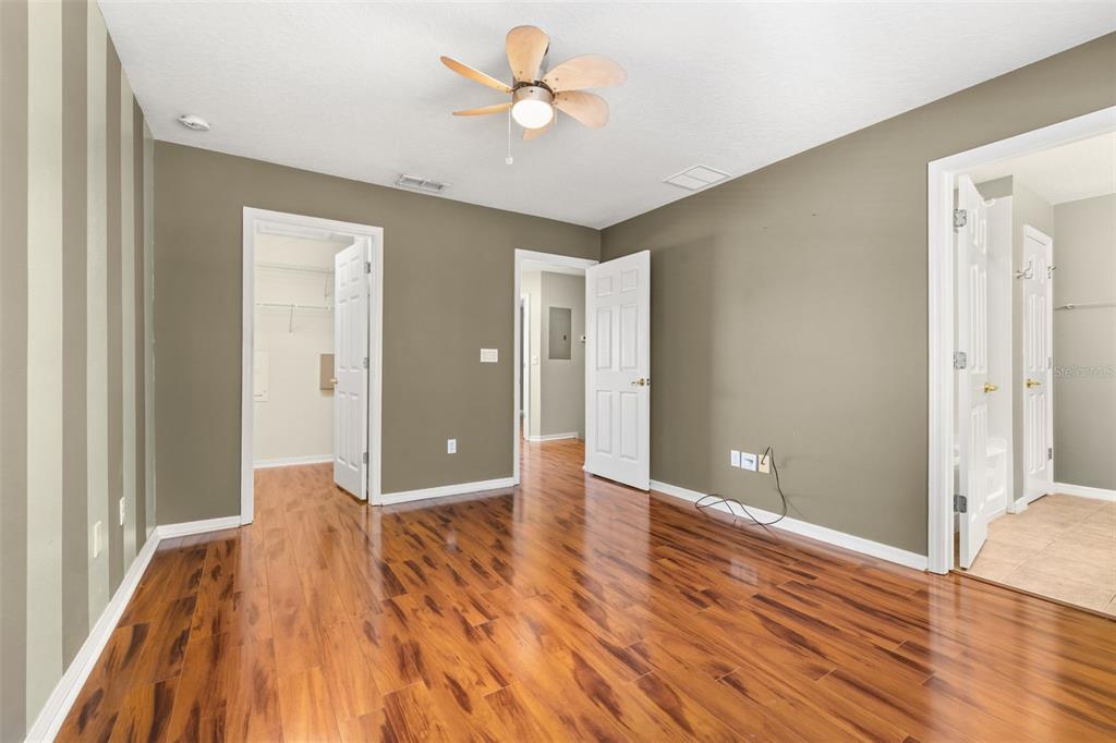 11781 Fitzgerald Butler Road Orlando, FL 32836 - Photo 22 of 37 a view of a big room with wooden floor and a ceiling fan