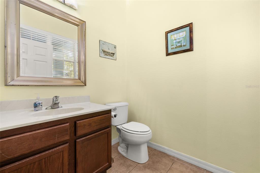 11781 Fitzgerald Butler Road Orlando, FL 32836 - Photo 7 of 37 a bathroom with a toilet a sink and a mirror