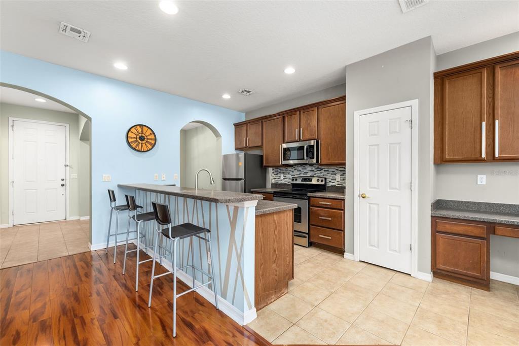 11781 Fitzgerald Butler Road Orlando, FL 32836 - Photo 10 of 37 a kitchen with a refrigerator a stove top oven a sink and dishwasher
